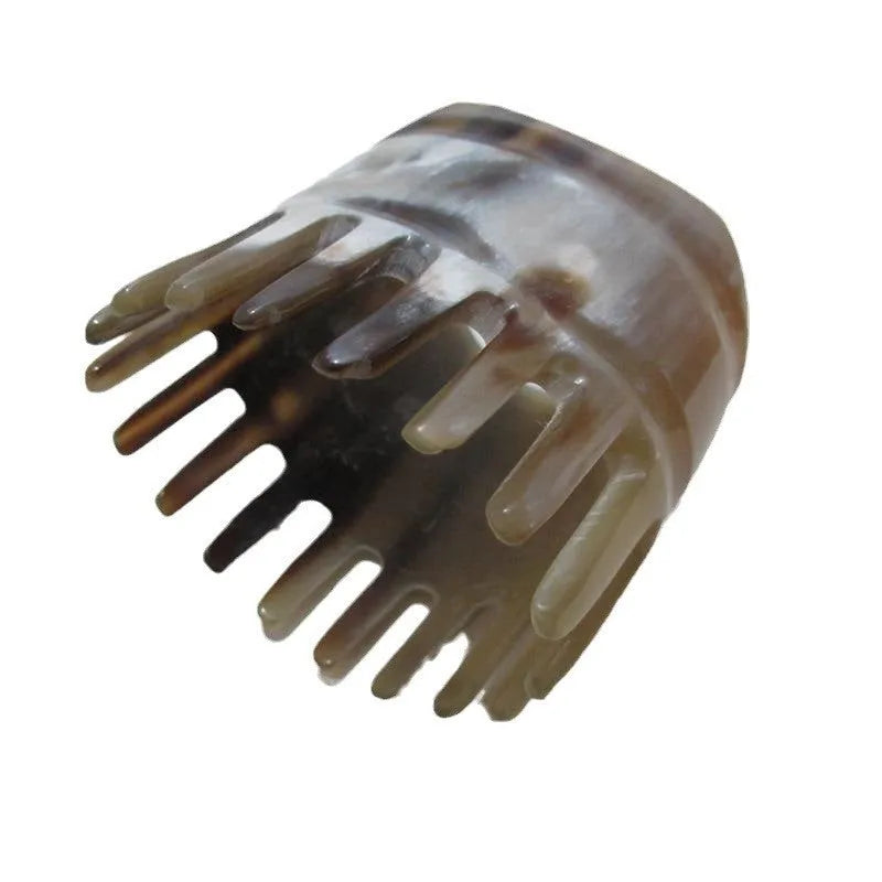 White buffalo horn meridian massage comb showing four different combing surfaces
