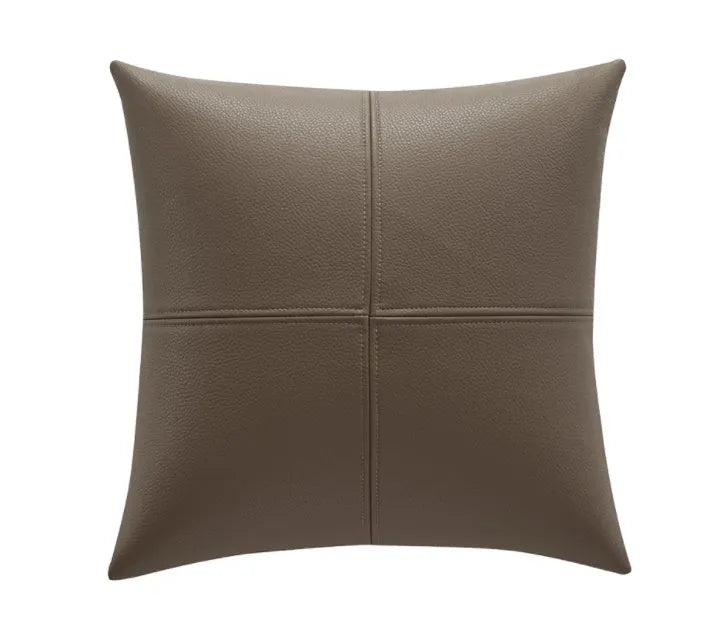 Simple solid colour cowhide leather pillow cover on a sofa, shown in a beige white colour.