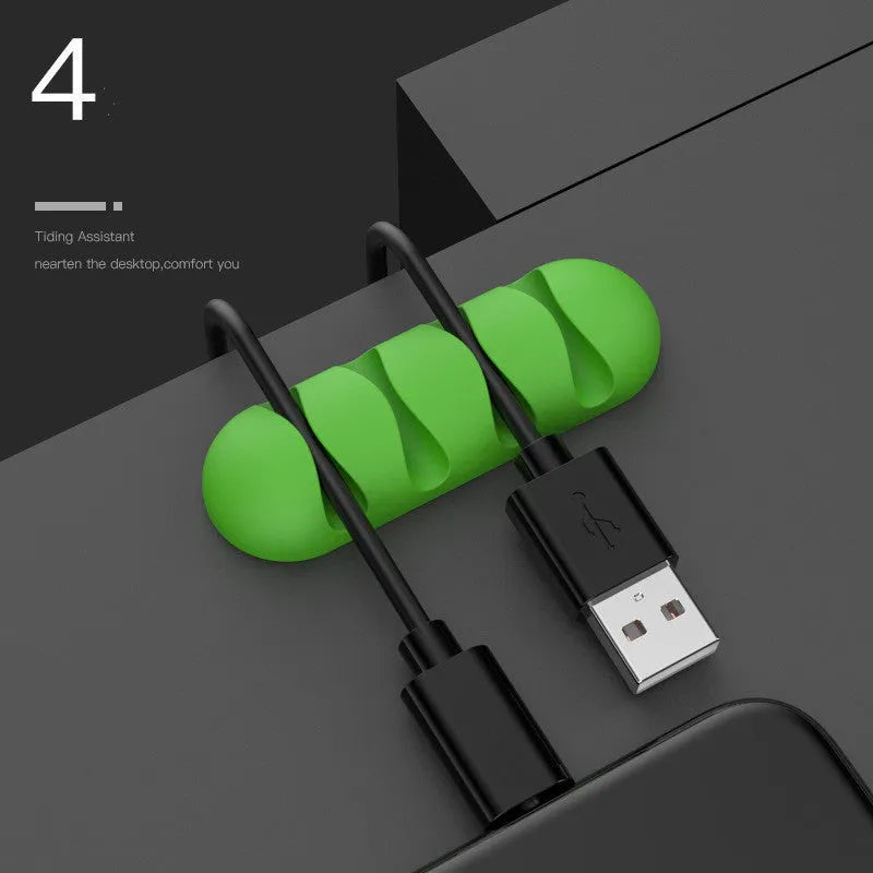 Smart cable holder with TPR flexible clips in black holding USB earphone and network cables on a desk