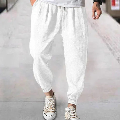 Men's cotton ankle banded trousers in light green colour showing loose fit and summer casual styling