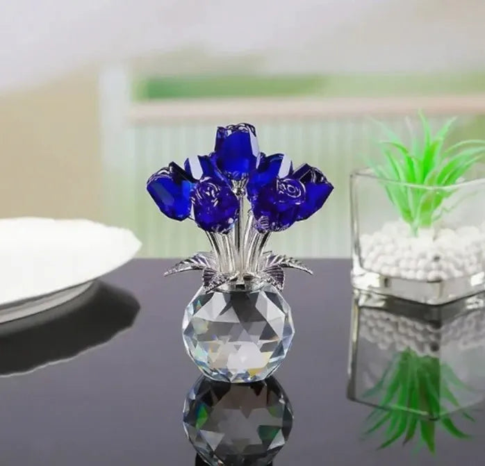 Geometric crystal glass rose ornament in red colour on wooden surface