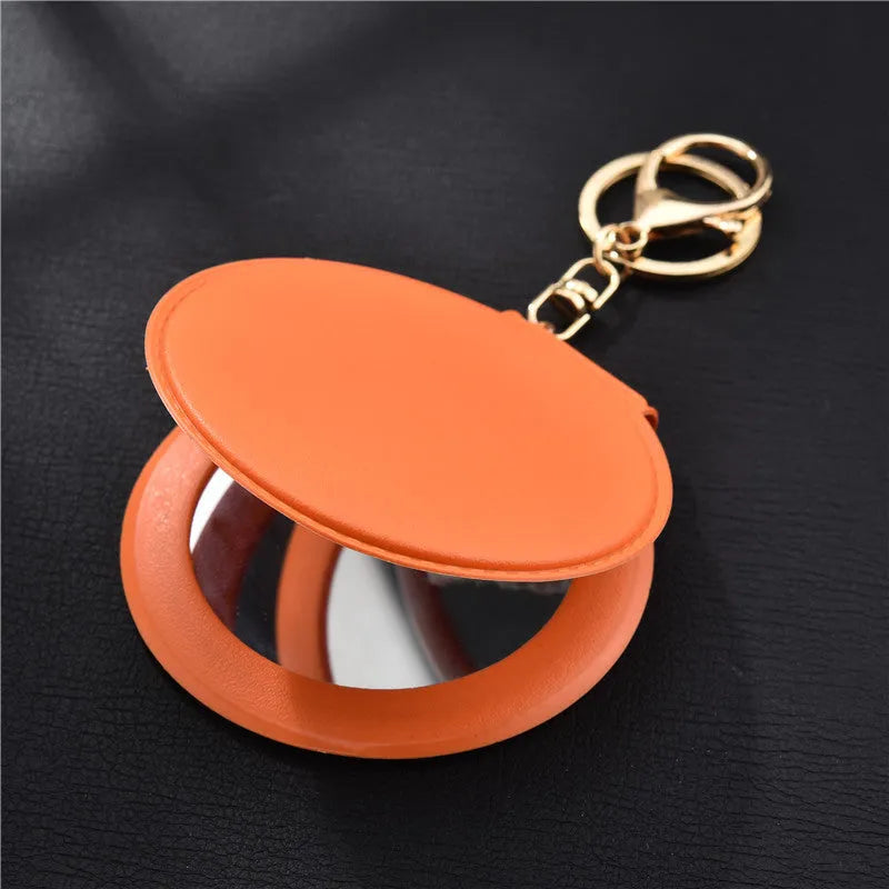Compact round ladies leather makeup mirror with 8cm diameter glass surface and golden buckle