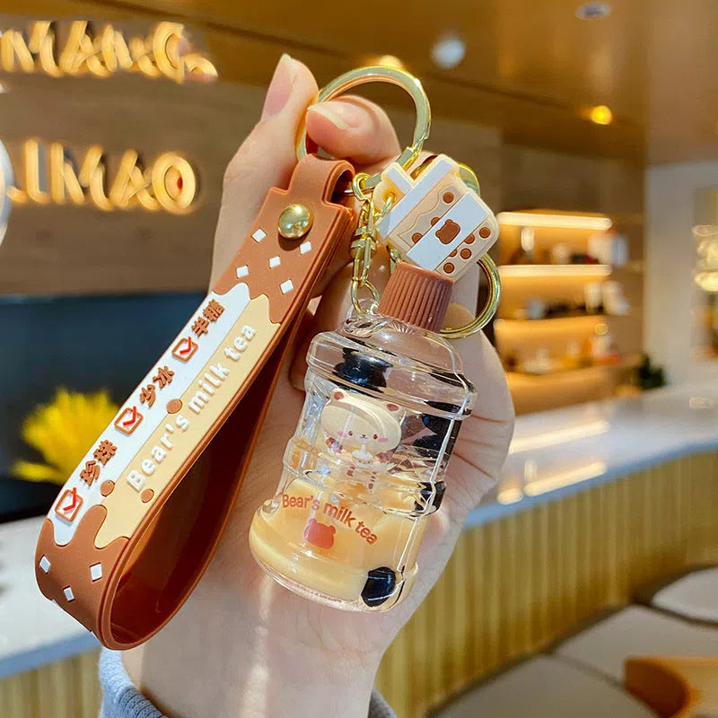 Oil-infused pearl milk tea bear keychain pendant in clear acrylic with alloy ring, featuring a drink bottle style design