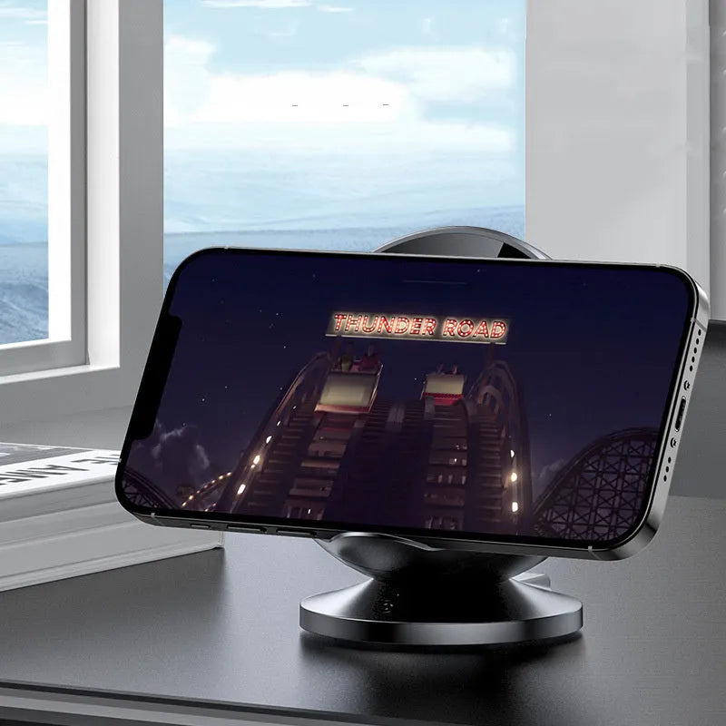 Black multifunctional mobile phone wireless charger holder with Bluetooth speaker, showing phone in cradle.