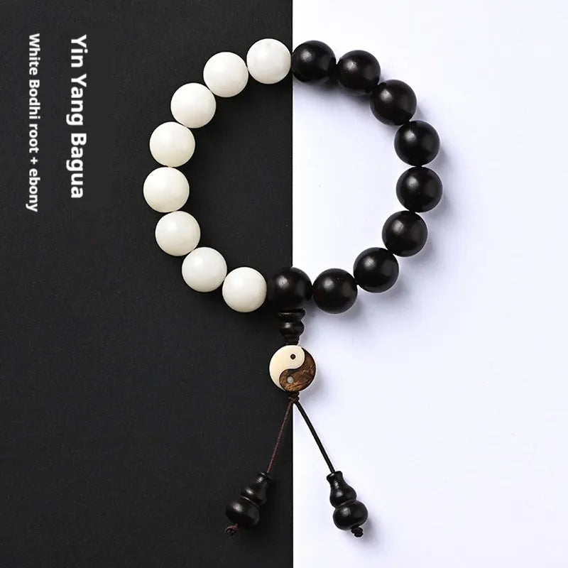 White and black bodhi seed bracelet with eight-diagram pattern, shown as a bracelet and lanyard.