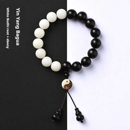 White and black bodhi seed bracelet with eight-diagram pattern, shown as a bracelet and lanyard.