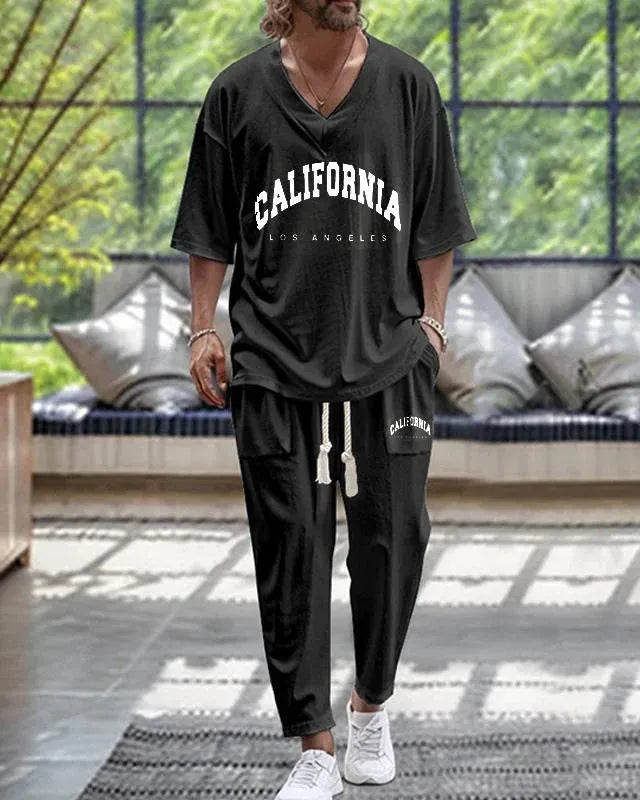 Thin polyester fibre co-ordinated suit with V-neck top, cropped sleeves, and matching trousers on a hanger.