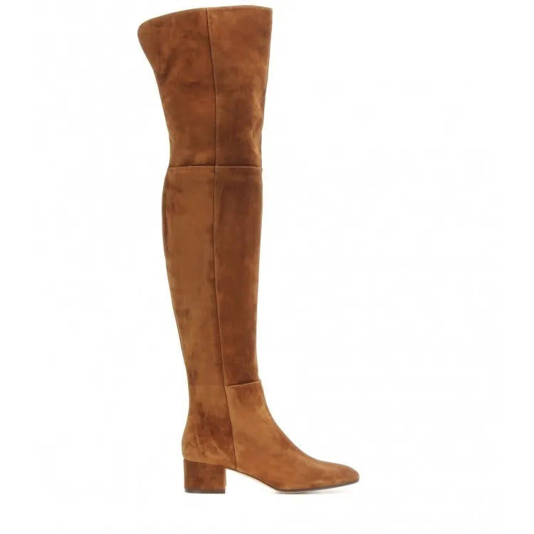 Women's grey suede over the knee flat boots with a low thick heel and pointed toe on a neutral background.