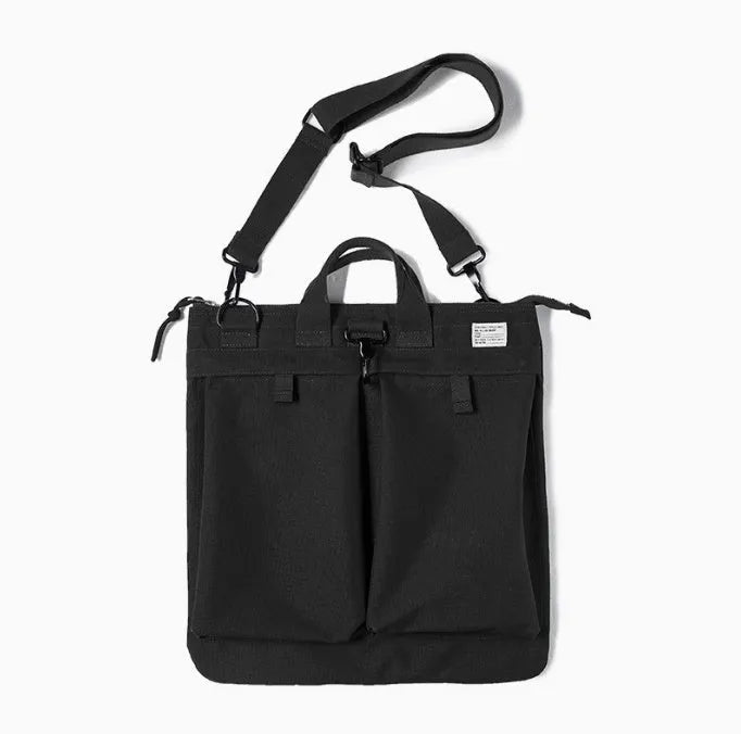 Medium canvas crossbody messenger bag in military green showing laptop compartment and shoulder strap