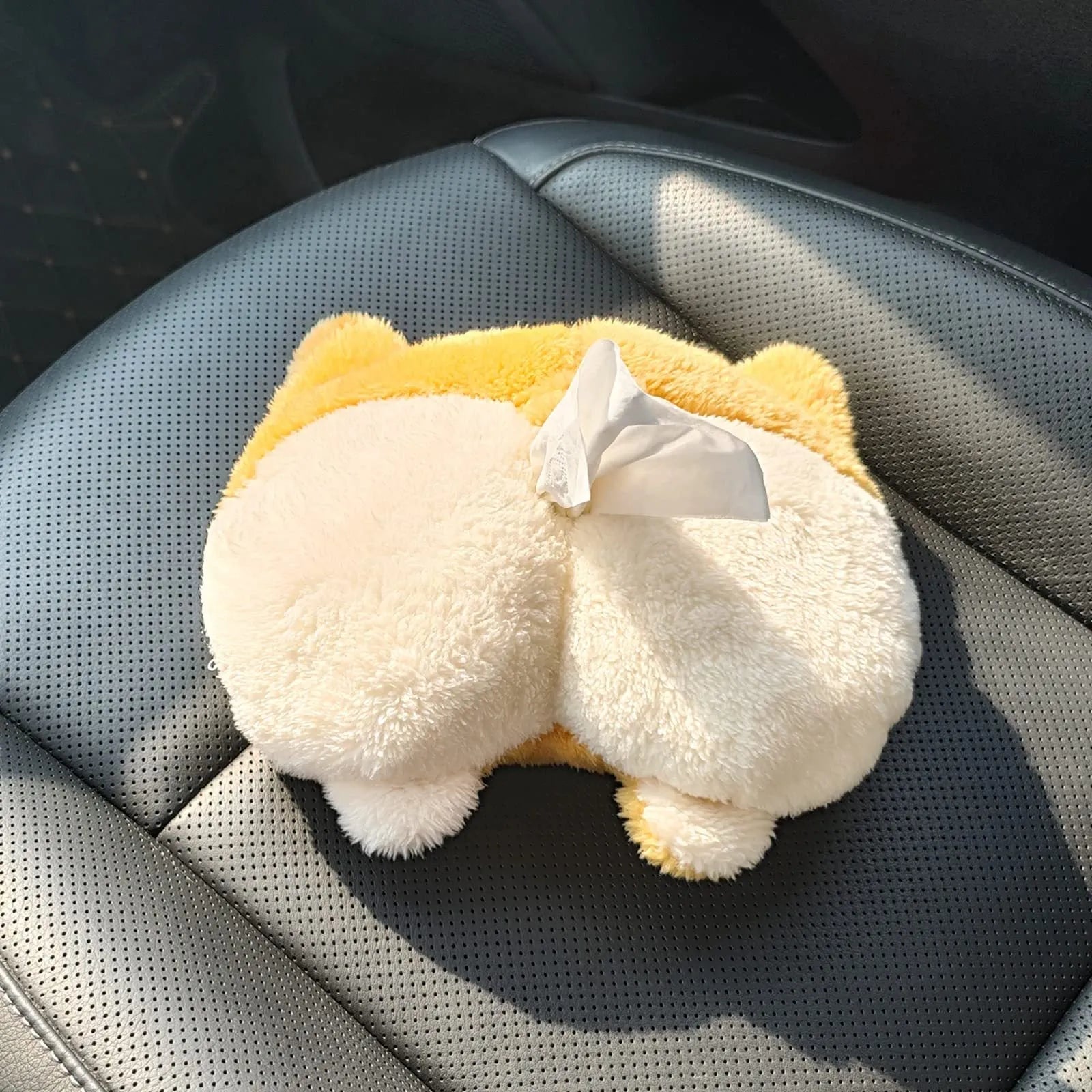 Yellow corgi butt-shaped car tissue box holder mounted on sun visor with elastic backing