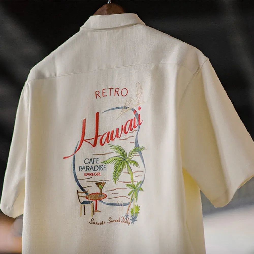 Light apricot men's shirt with bamboo and flower pattern and a Cuban collar.