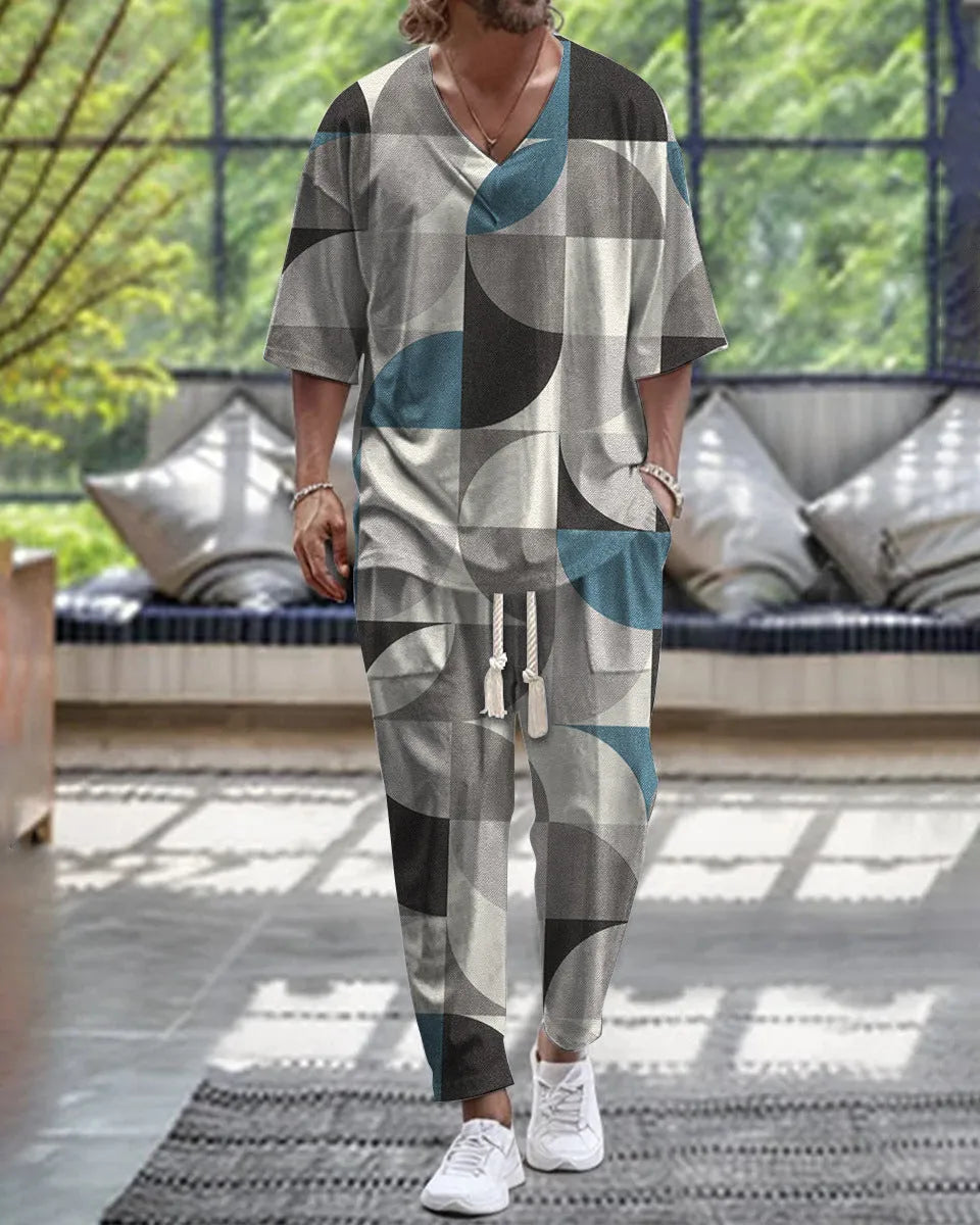 Thin polyester fibre co-ordinated suit with V-neck top, cropped sleeves, and matching trousers on a hanger.