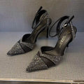 Women's black and silver hollow high heels with red soles, stiletto heels, and pointed toe design