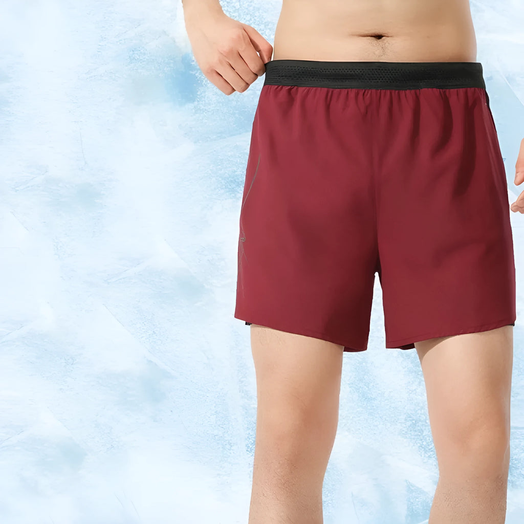 Men's solid colour polyester basketball shorts with low waist design on a neutral background.