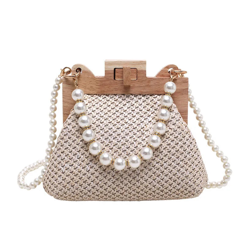 Women's woven straw shoulder bag with pearl chain strap in horizontal square shape