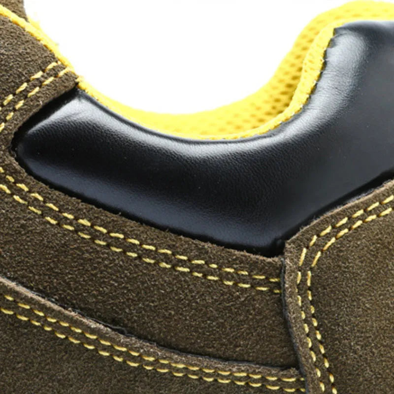 Bronze coloured leather safety boots with steel toe cap on a work site background