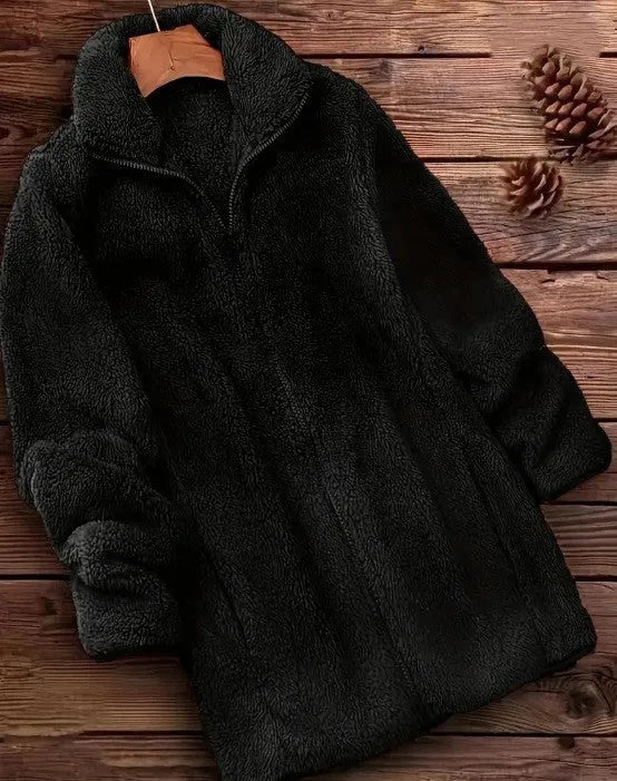 Man wearing a black double-sided fleece jacket outdoors, showing soft texture.