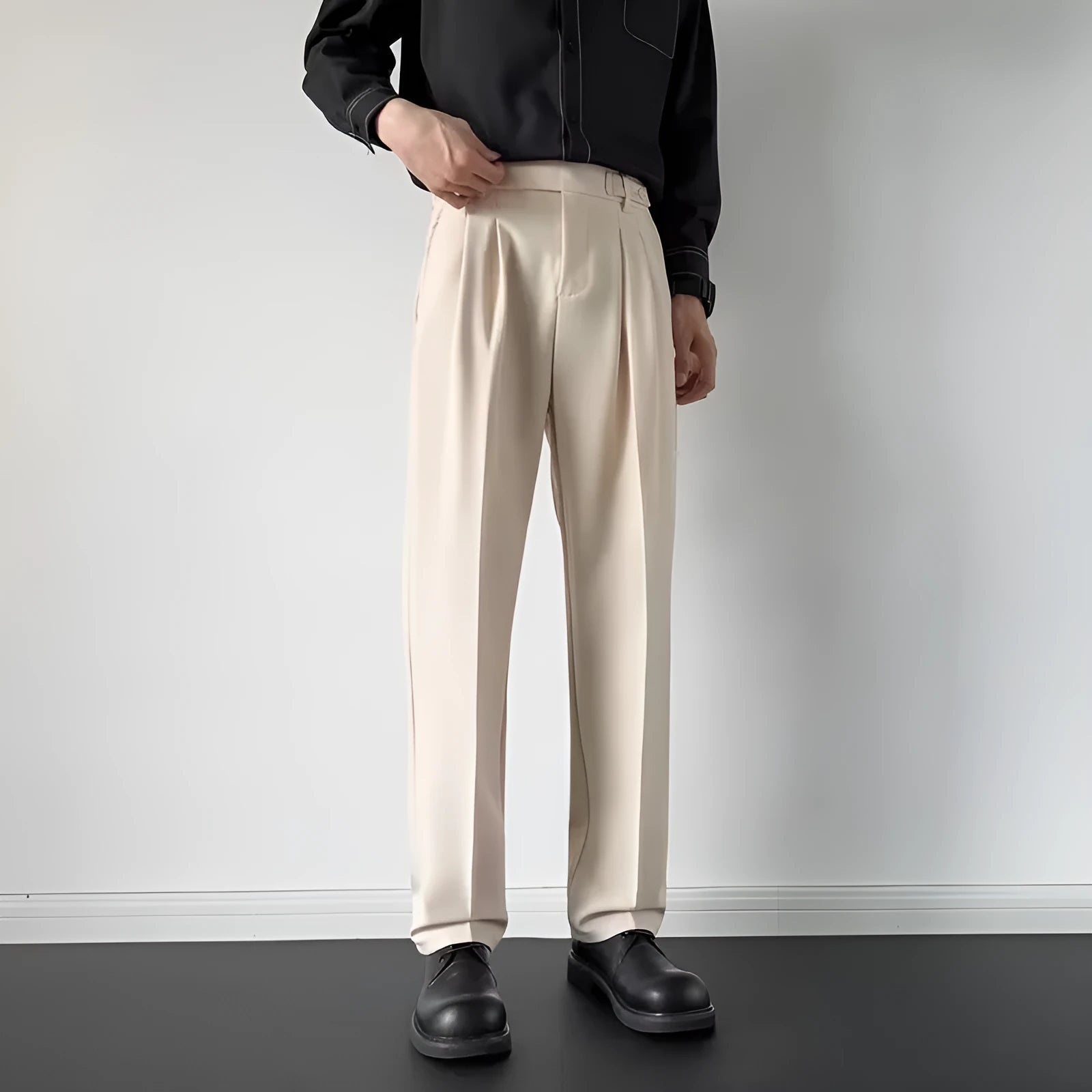 Men's apricot and black straight-leg loose fit suit trousers on a hanger