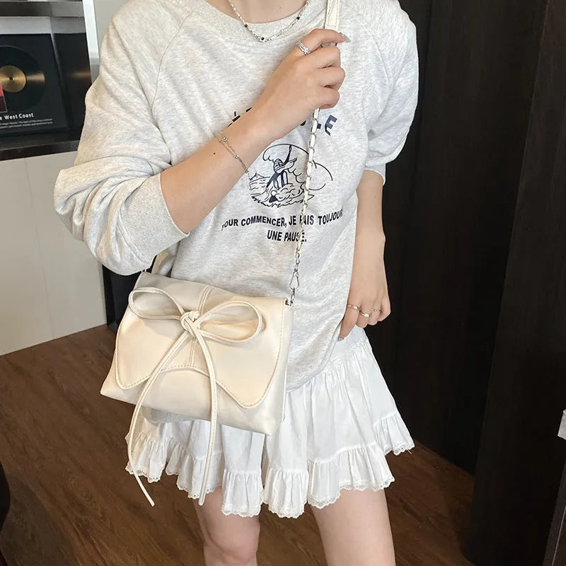 Women's underarm crossbody bag in horizontal square shape with sandwich pocket design and crossbody strap