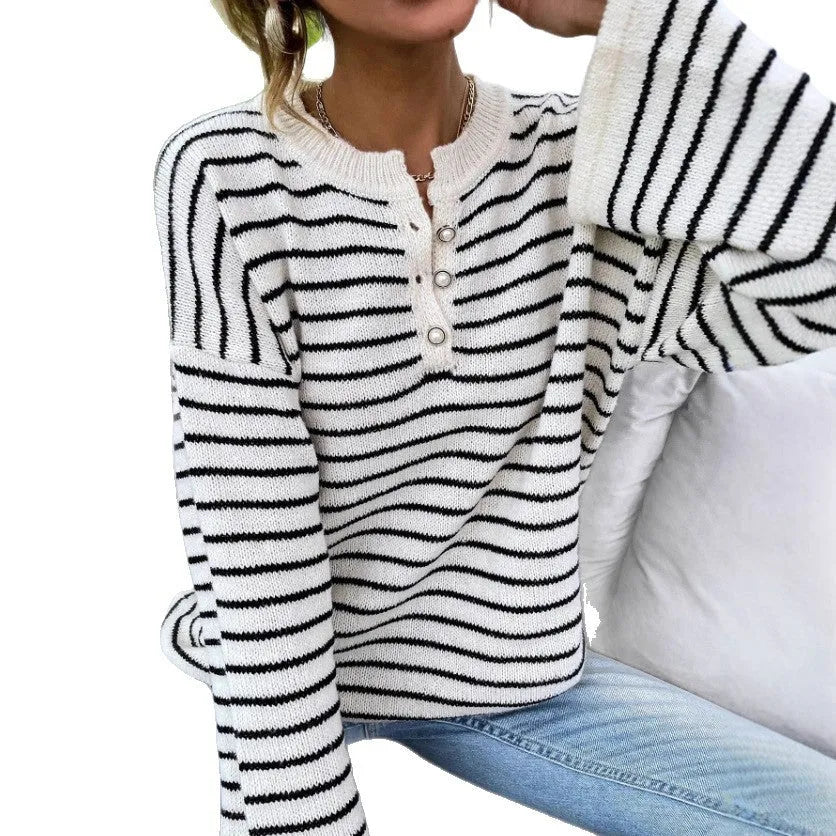 Black and white striped women's loose-fit long sleeve top with drop shoulders and button front.