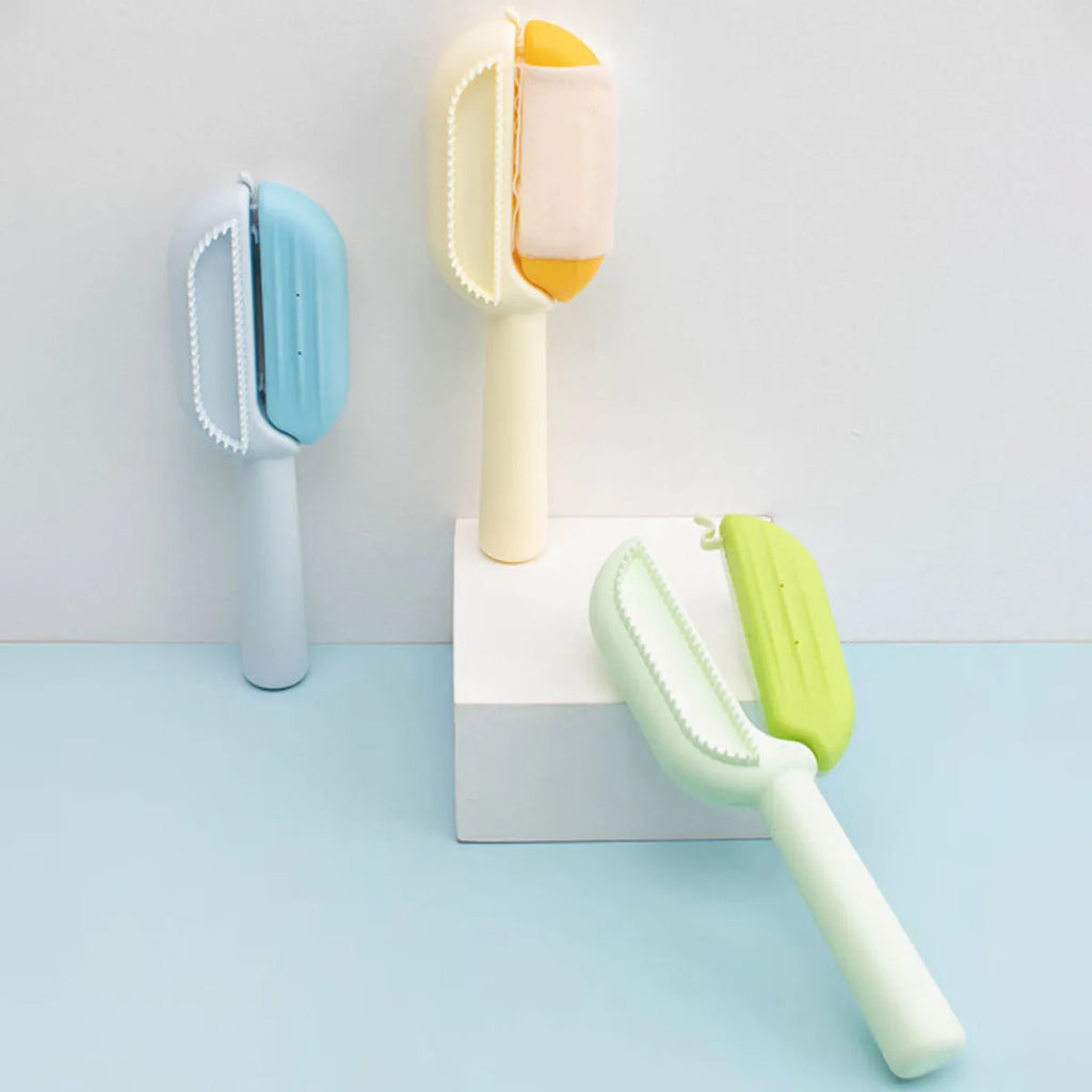 Blue pet grooming comb with water tank for dogs and cats on a white background.