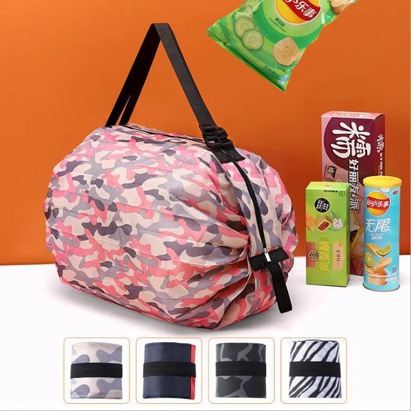 Foldable large-capacity shopping bag in 210d Oxford cloth with pink camouflage colour, hanging on a wall hook