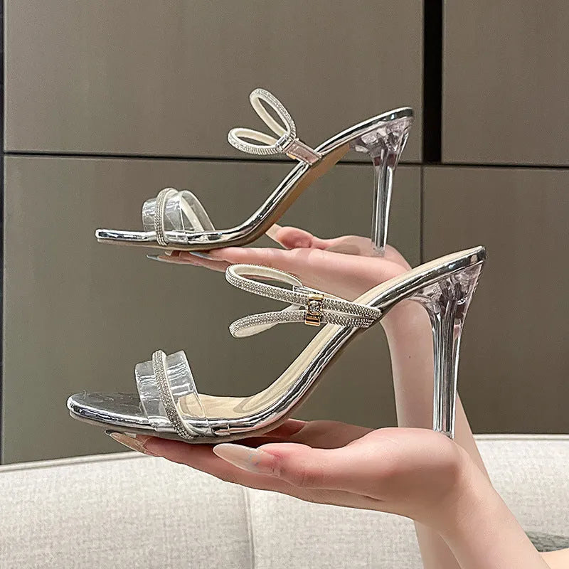 Women's black rhinestone stiletto heel sandals with round toe and PU upper on a white background