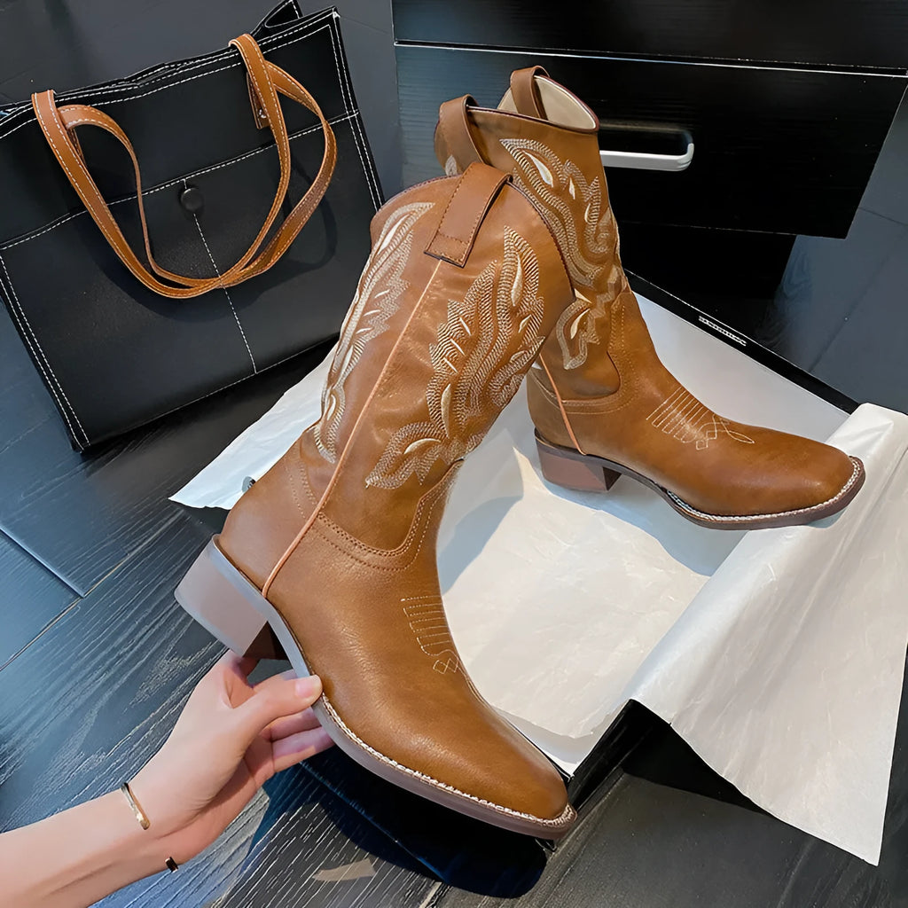 Brown women's Martin boots with embroidered toe cap and mid-calf height.