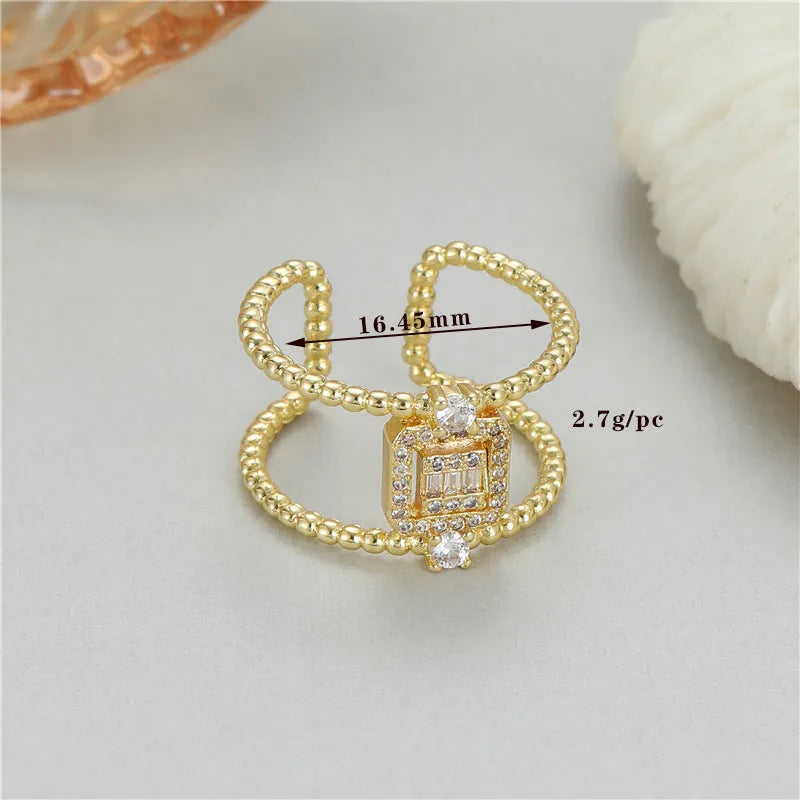 Adjustable open mouth copper ring with asymmetric U-shape and gold plating.