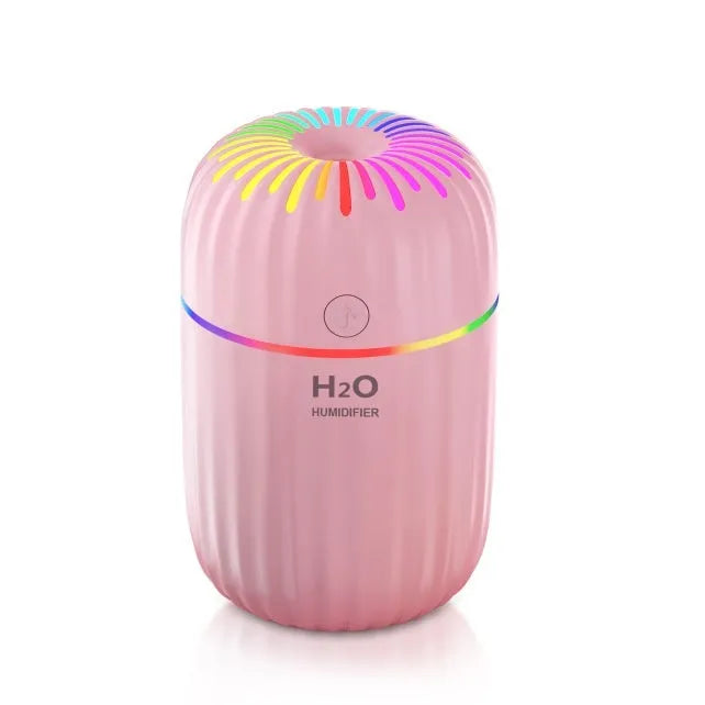 Compact white USB mini humidifier with 300ml water tank on desk beside laptop