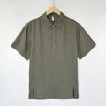 Men's loose fit linen summer top with short sleeves and thin lapels on a hanger.