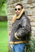 Brown retro-style men's synthetic leather fur coat with side pockets and a straight hem.