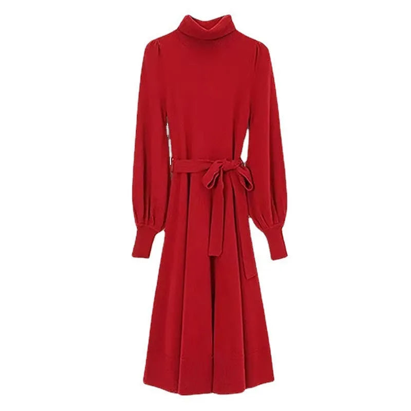 A rose red turtleneck knit dress with long sleeves, an elastic waist, and a loose mid-length skirt on a hanger.