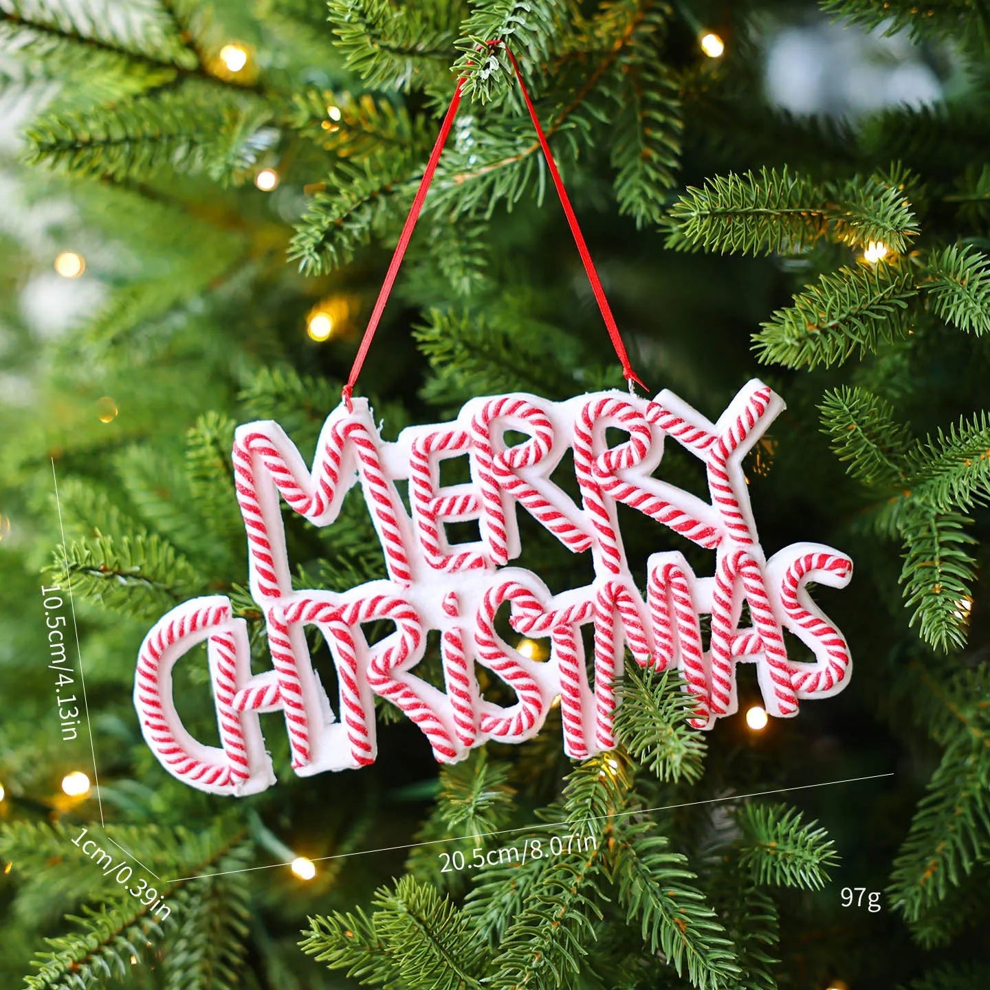 Merry Christmas letter plate polymer clay tree ornament in red, white and green plastic hanging on a tree branch
