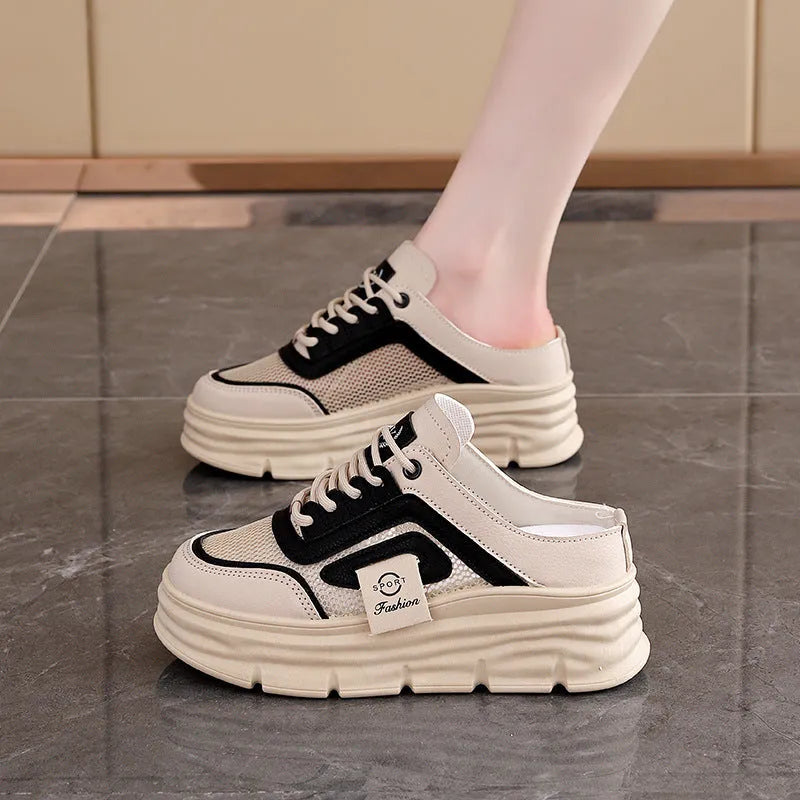 Women's black mesh half slippers with a round toe and rubber sole, shown from the side.