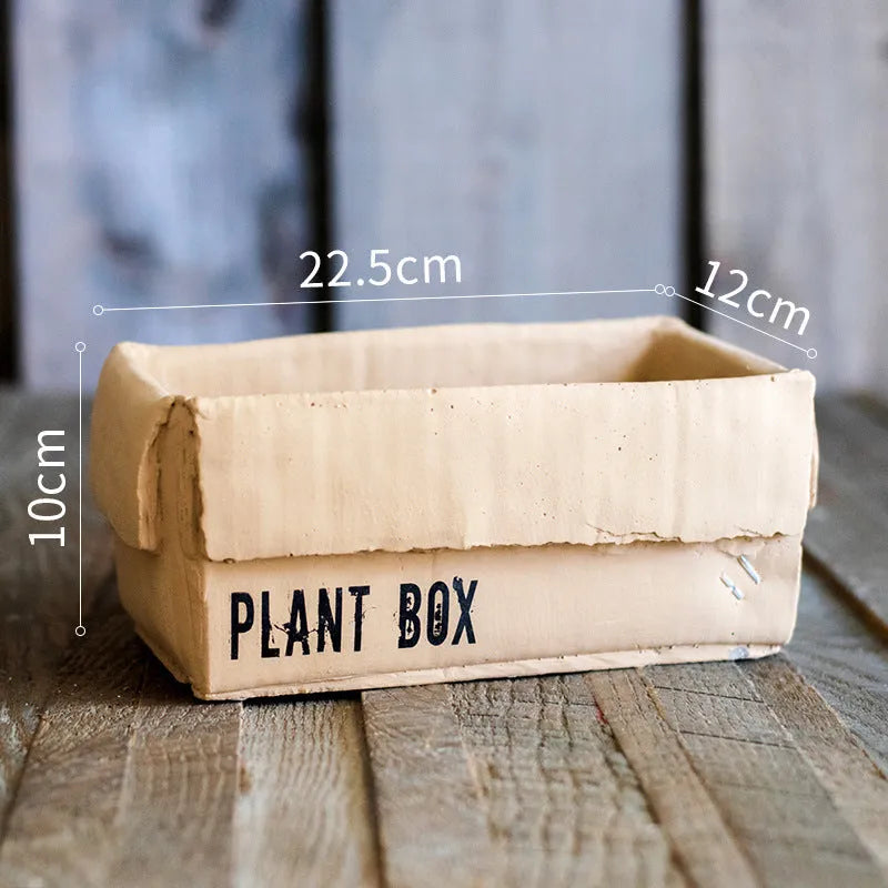 Cement brown paper box style flowerpot with a drainage hole, shown in a Nordic interior setting.