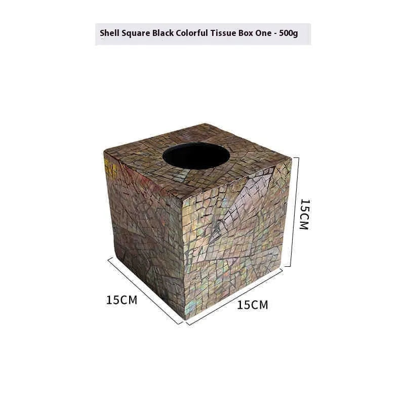 Black natural shell tissue box storage organiser with removable compartment on a coffee table.