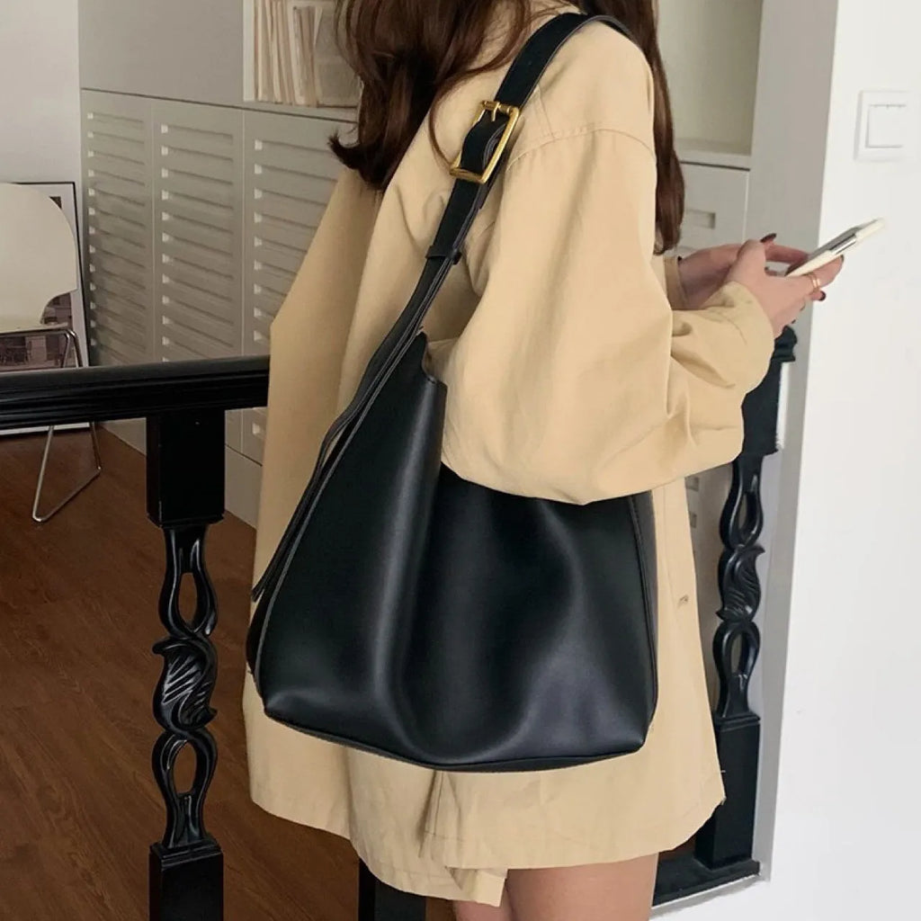 Women's soft PU shoulder bag with swing threads in black or brown colour options