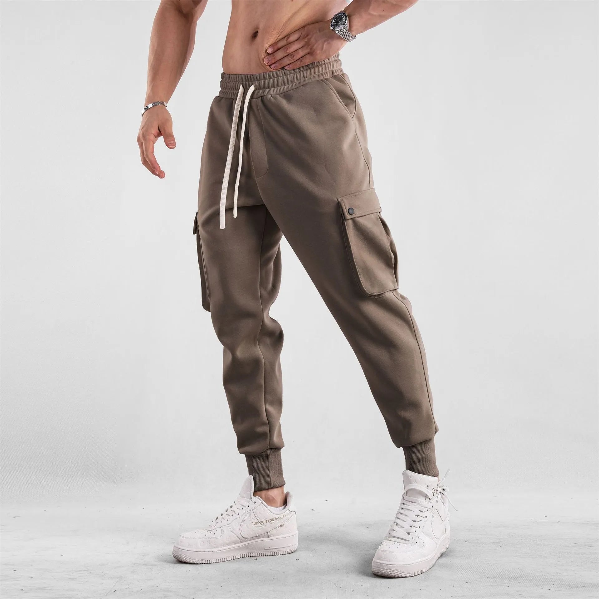 Men's cotton sports trousers with ankle ties and multiple pockets in apricot colour