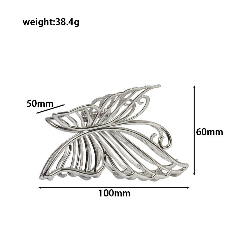 Assorted silver metal hair claws and barrettes including wave, knot, bow, and pearl designs on a white background.