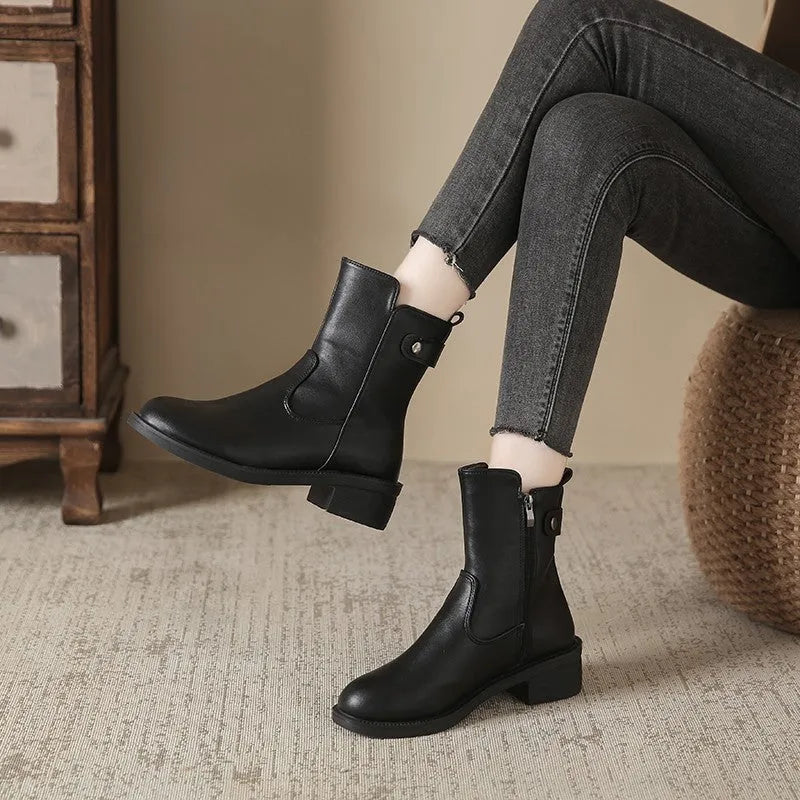 Black women's ankle boots with side zip, round toe, and a low block heel.