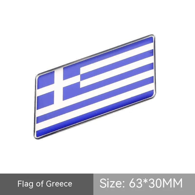 Aluminium parallelogram car sticker showing a national flag design, measuring 6.3 by 3 centimetres.