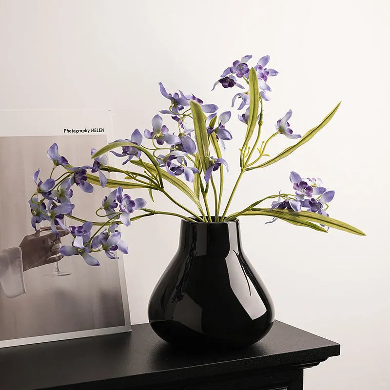 Ceramic decorative vase with orchid flowers in modern simplicity style