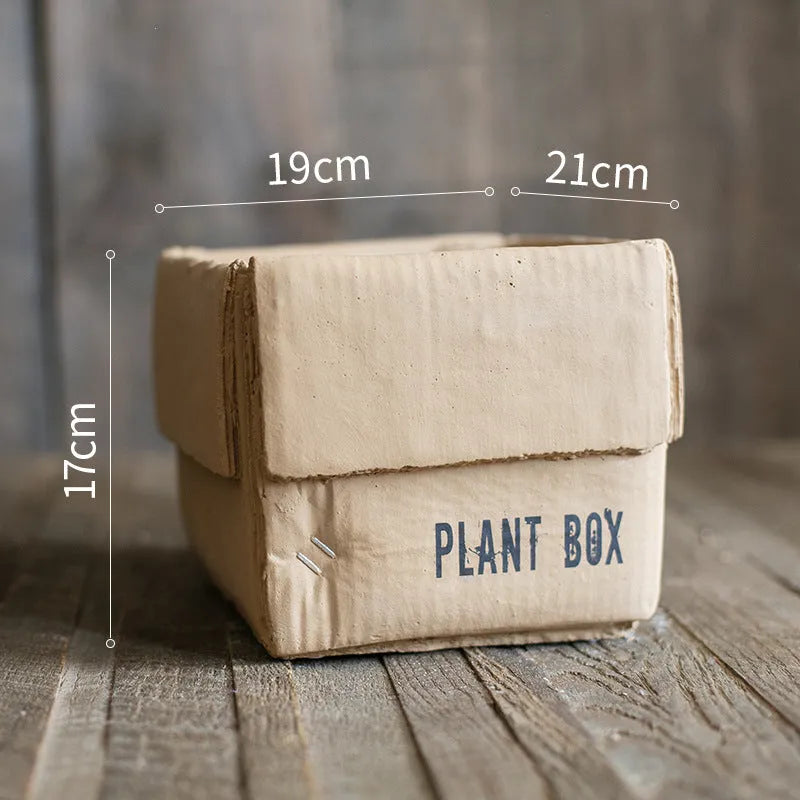Cement brown paper box style flowerpot with a drainage hole, shown in a Nordic interior setting.
