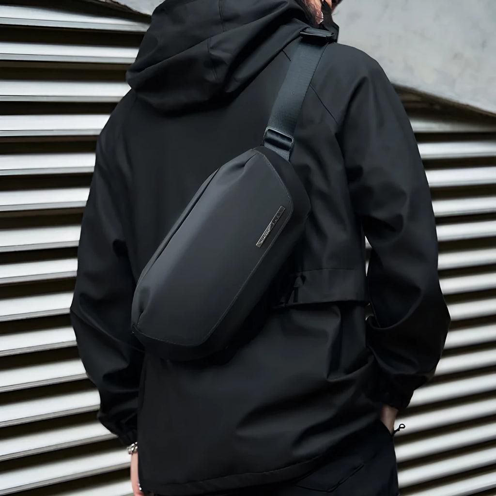 Black men's messenger bag in Oxford cloth with cross-body strap and street style detailing.