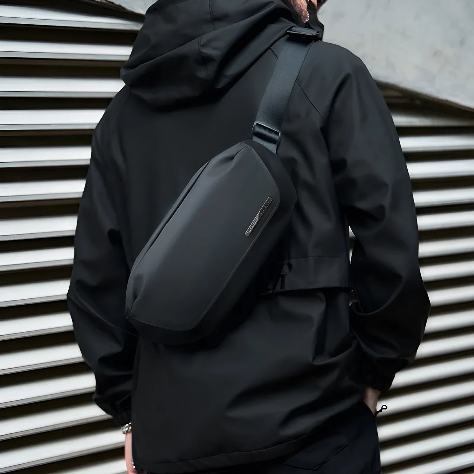Black men's messenger bag in Oxford cloth with cross-body strap and street style detailing.