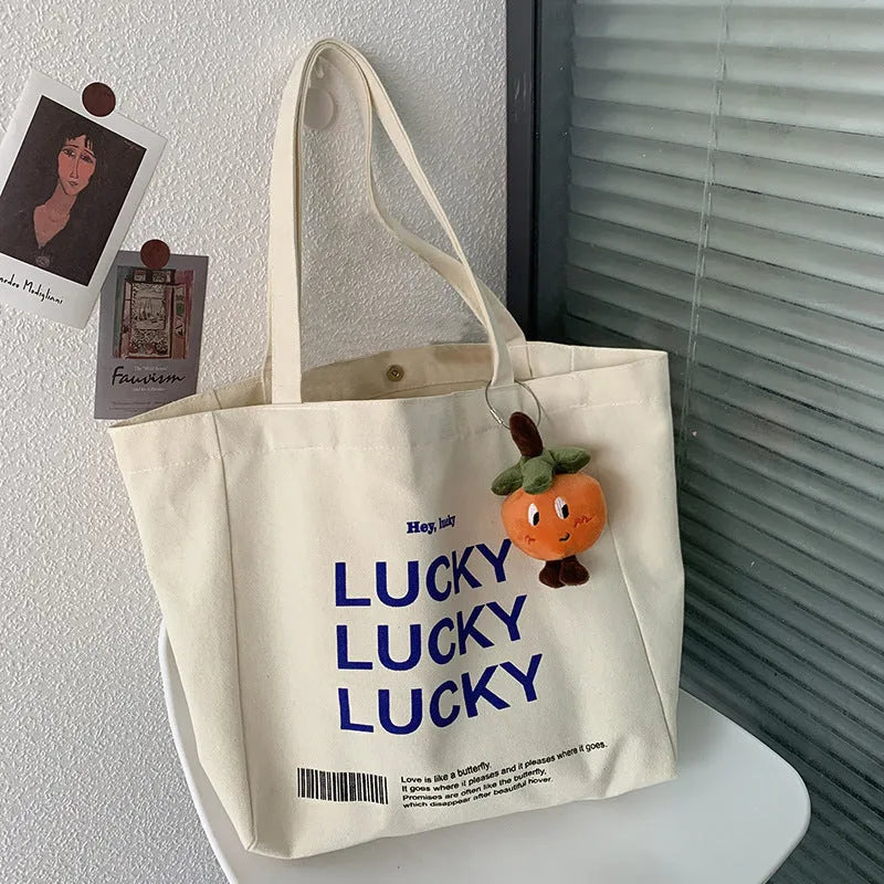 Natural colour canvas tote bag with metal magnet buckle closure and small front pocket, 32x31.5x10cm