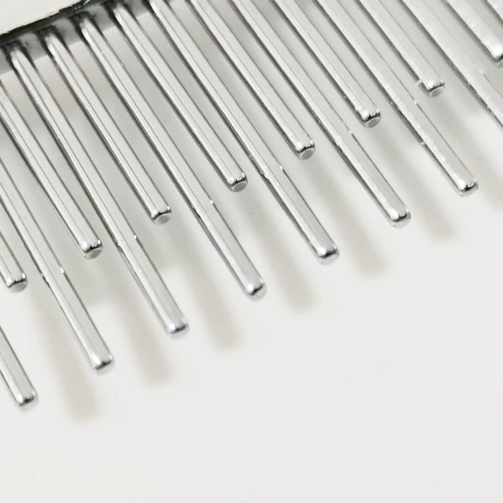 Red pet grooming comb with stainless steel pins, showing both long and short teeth on a plastic handle.