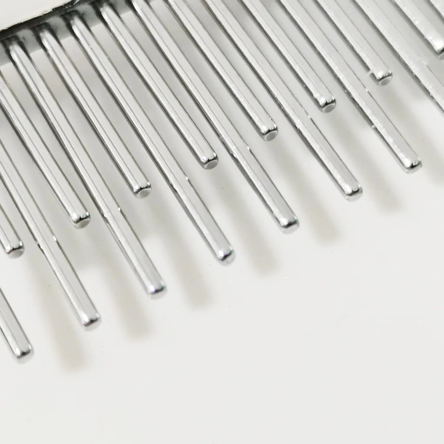 Red pet grooming comb with stainless steel pins, showing both long and short teeth on a plastic handle.