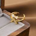 Gold geometric open ring for women on a grey background.
